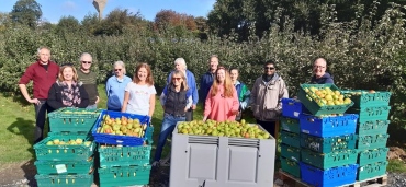 People standing in front of apples